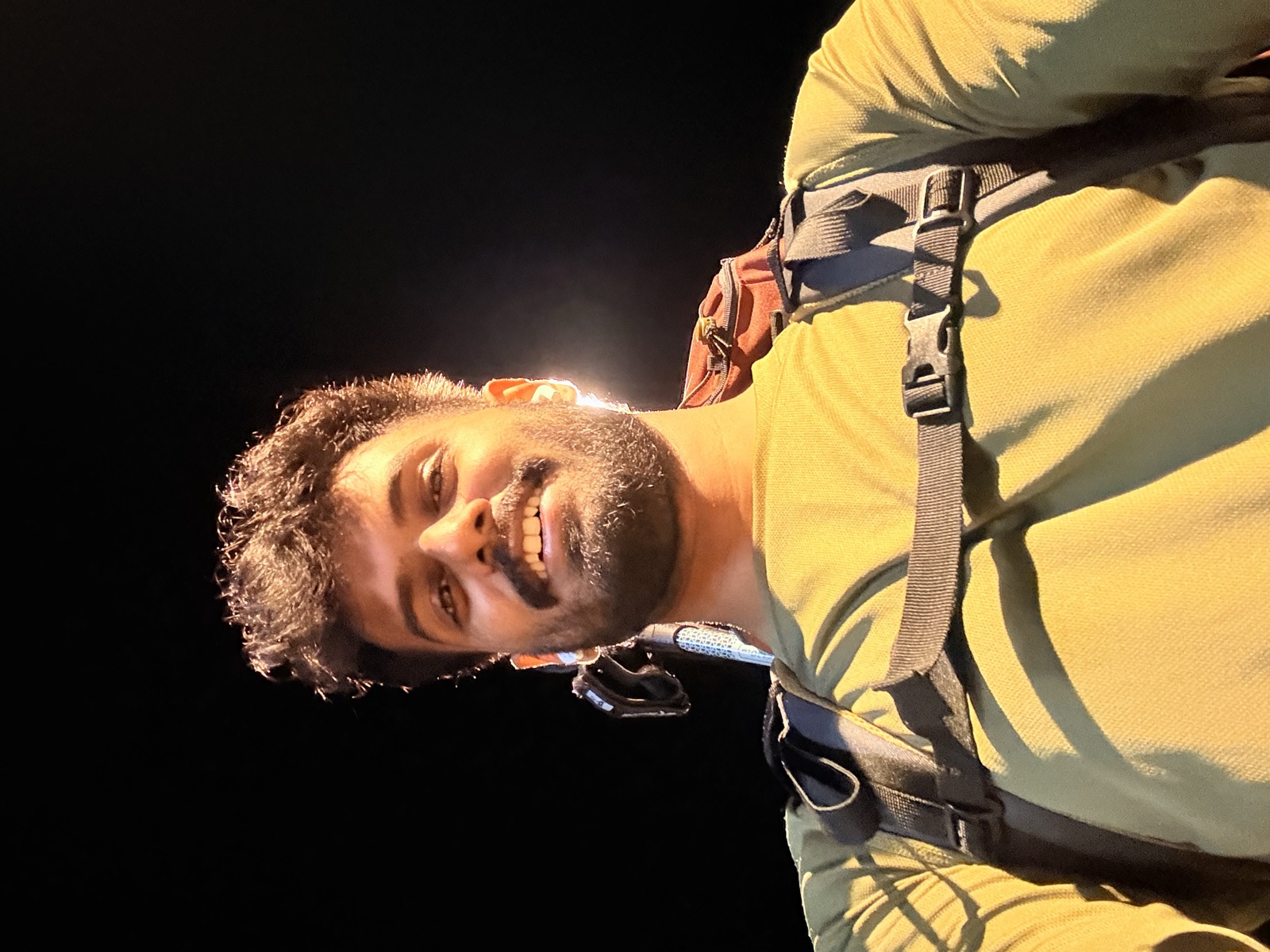 Selfie in the dark at 00:54, backpack on, lit by headlamp