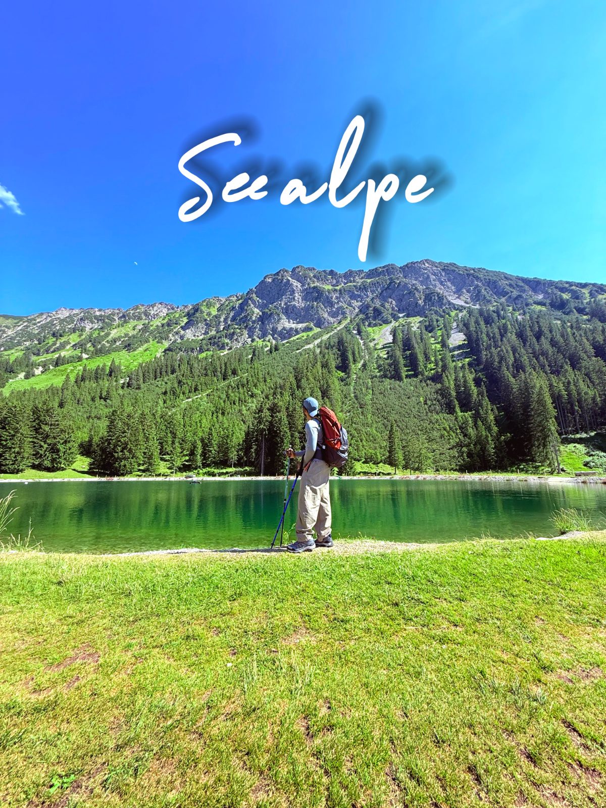 Seealpsee lake with green slopes, standing at the shore
